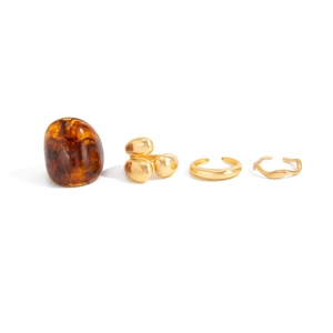 Set of four gold metal and amber resin rings including organic and wavy band designs
