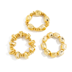 3-piece set of gold geometric resin rings with irregular hammered stone texture on white background