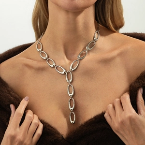 Elegant silver long Y-shaped necklace with large oval links on a fashion model