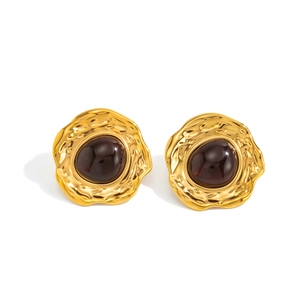 Vintage gold hammered metal stud earrings with dark red gemstone inlay in retro style