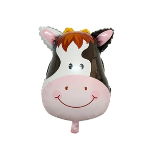 Close-up of a cartoon cow foil balloon with soft pink and brown details for parties