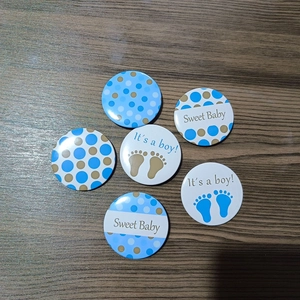 Set of six blue It's a Boy tinplate badges with polka dots for gender reveal parties