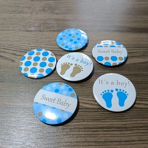 Set of 6 blue Baby Boy gender reveal tin badges with dots and It's a boy text