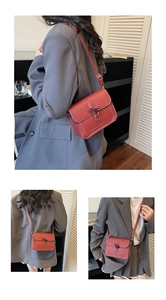 Detailed view of a retro red leather crossbody bag with white stitching and metal buckle