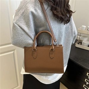 Brown textured rectangular tote bag with elegant handles and adjustable shoulder strap