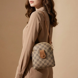 Elegant brown checkered crossbody phone bag with leather flap shown on a model