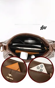 Detail view of brown leather tote bag interior with multi-layer zipper compartments