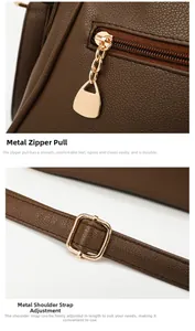 Detailed macro view of golden zipper head and adjustable shoulder strap buckle on brown bag