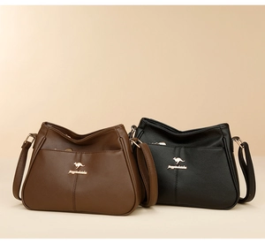 Close-up of pebble-textured crossbody bags in black and brown with golden kangaroo logos