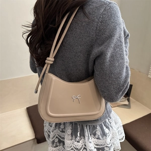 Elegant apricot bow underarm bag in minimalist leather design for women's winter style