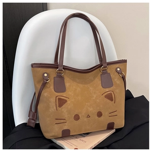 Detailed close-up of cat embroidery on a caramel brown suede tote bag for women