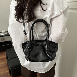 Large capacity black glossy patent leather tote bag with pleated design and shoulder strap