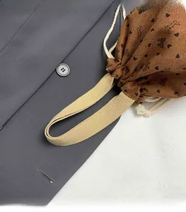 Detail of brown corduroy bucket bag with bear print and sturdy woven handles