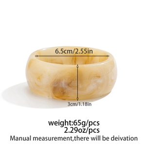 Macro detail of amber resin bangle showing dimensions 6.5cm diameter and 3cm width