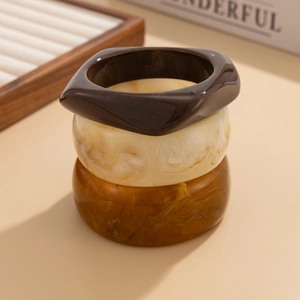 Three-piece set of retro resin bangles in amber, cream marble, and dark coffee colors