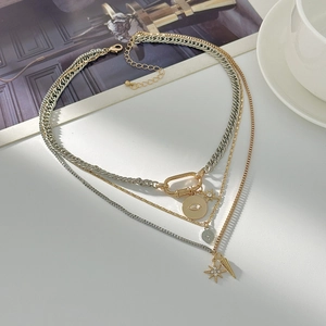Close-up of layered necklace with cross pendant, mixed chains and silver-gold star charms