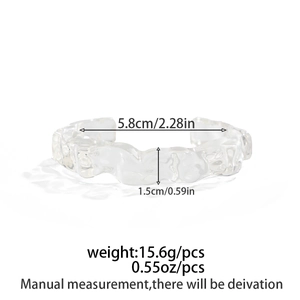 Detailed view of transparent resin cuff bracelet with wave texture and dimension labels