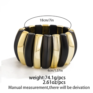 Detail of wide elastic bracelet with matte black and gold modules showing 18cm circumference