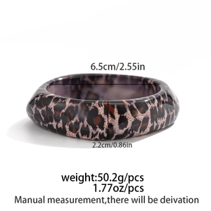 Detail view of resin leopard print bangle with dimensions 6.5cm diameter and 2.2cm width