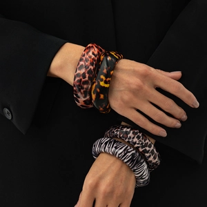 Retro resin chunky bracelets with leopard and zebra prints on a black background