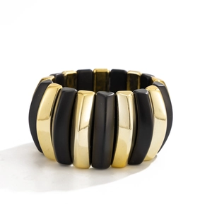Modern wide elastic bracelet featuring alternating matte black and shiny gold metal blocks