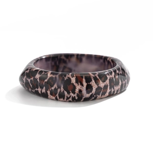 Wide leopard print resin bangle for women featuring polished finish on white background