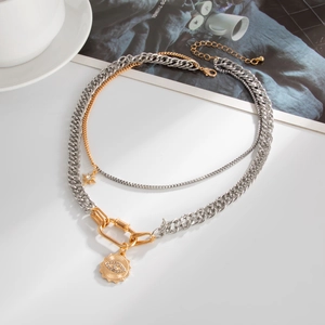 Layered gold and silver necklace with evil eye star pendant and chunky cuban chain