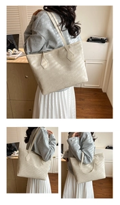 Detail of cream woven tote bag showing premium texture and shoulder strap for daily commuting