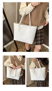Detail view of large white woven textured tote bag showing high-capacity design and straps