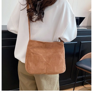 Detailed view of caramel corduroy tote bag with dual front pockets and soft ribbed texture