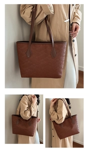 Close-up of dark brown tote bag featuring textured woven pattern and smooth leather straps