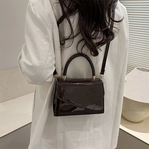 Dark coffee patent leather crossbody bag with V-shaped flap and gold hardware