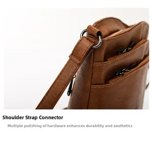 Detail of polished dark gray metal buckles and neat stitching on brown leather bucket bag