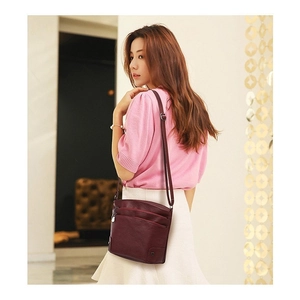 Retro dark red pebbled leather crossbody bag with multiple zippers and adjustable strap