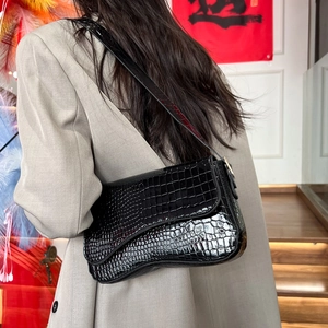 Glossy black croc-embossed saddle shoulder bag with a minimalist chic patent leather finish