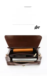 Detail view of the brown leather bag inner compartments and multi-pocket storage layout