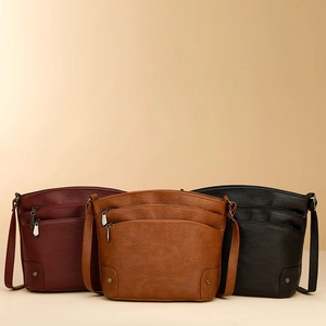 Retro faux leather crossbody bag with dual zipper pockets in red, tan and black