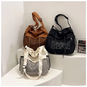 Detail of canvas crossbody bags with ULTRA letters and adjustable straps in three colors