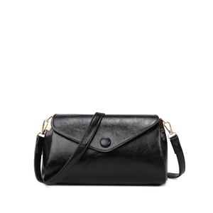 Minimalist black glossy faux leather shoulder bag with gold hardware and envelope flap