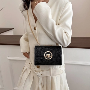 Chic black crocodile embossed mini crossbody bag with gold chain strap for women