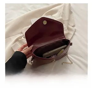Macro detail of the interior space of the burgundy envelope chain bag for women