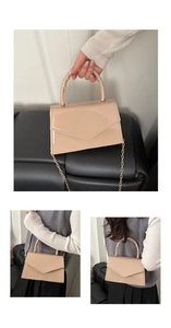 Detail of glossy beige patent leather bag with gold chain strap and envelope flap design