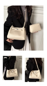 Detail of cream white faux leather 2-piece bag set with adjustable silver hardware straps