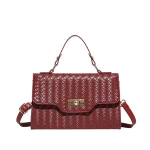 Fashionable dark red woven leather handbag with gold twist lock and shoulder strap