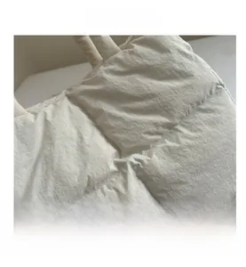 Detailed view of the beige quilted tote bag showing high-quality stitching and nylon texture