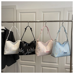 Macro shot of stylish pleated underarm bags in four colors with embossed wavy textures