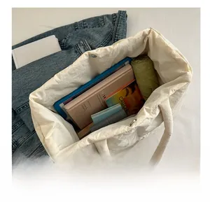 Top view of white quilted puffer tote bag showing large capacity for books and tablet