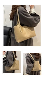 Détail du grand sac cabas en cuir kaki avec surpiqûres contrastées et design spacieux