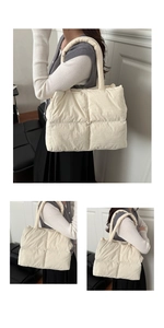 Detail of soft cream white quilted puffer tote bag with padded handles and fluffy texture