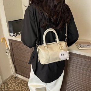 Chic cream Boston bag with Fashion Air Paris embossing and a cute plush charm